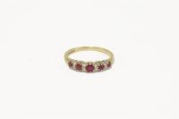 Lot 19 - A 9ct gold graduated ruby and diamond half hoop ring