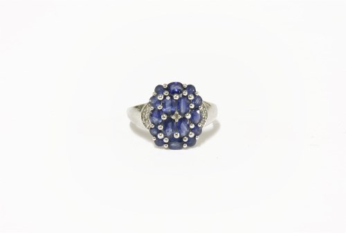 Lot 27 - A 9ct white gold sapphire and diamond cluster ring