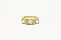 Lot 29 - An 18ct gold three stone graduated opal cabochon ring