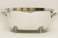 Lot 390 - A silver plated champagne bath of ovoid form on four paw feet with fitted twin handles