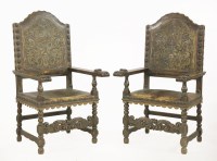 Lot 545 - A set of fourteen Continental walnut and leather dining chairs