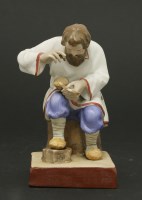 Lot 63 - A Russian ceramic seated figure