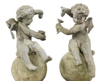 Lot 643 - A pair of lead cherubs on stone balls