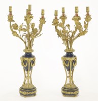 Lot 558 - A pair of French gilt metal and blue royal candelabra