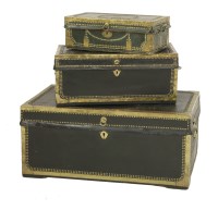 Lot 588 - A matched set of three camphorwood and leather chests