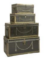 Lot 589 - A matched set of four camphorwood and leather chests