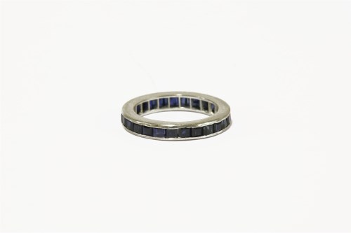 Lot 29 - A white gold channel set sapphire full eternity ring