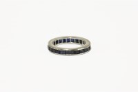 Lot 29A - A white gold channel set sapphire full eternity ring