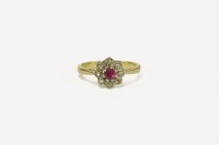 Lot 31 - An 18ct ruby and diamond flower set ring