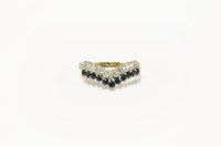 Lot 33 - A 9ct gold two row sapphire and diamond half wishbone ring