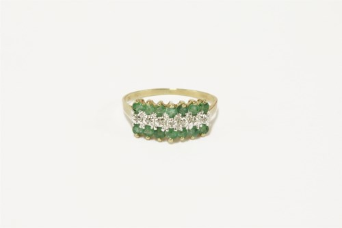 Lot 35 - A gold three row diamond and emerald ring