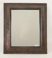 Lot 605 - An ebonised tortoiseshell mirror