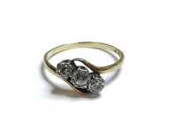 Lot 66A - A gold three stone diamond crossover ring