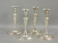 Lot 479 - A set of four Sheffield plated candlesticks