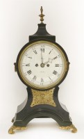 Lot 298 - A Regency period ebonised balloon-shaped mantel clock