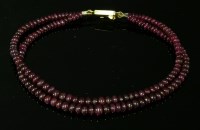 Lot 222 - A two-row graduated ruby bead bracelet