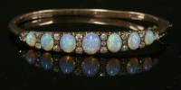Lot 67 - A late Victorian opal and diamond hinged bangle