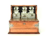 Lot 358 - A Victorian oak three bottle tantalus