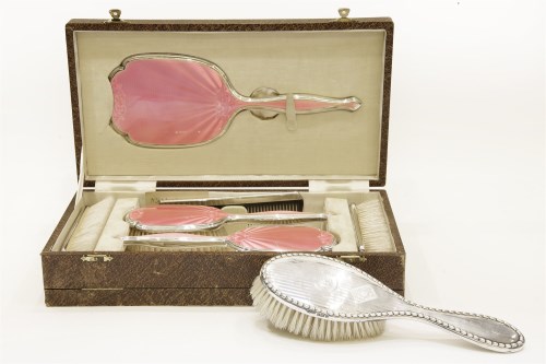 Lot 1251 - A cased Art Deco silver and pink guilloché vanity dress set