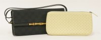 Lot 1028 - A Gucci Monogram Bamboo clutch bag
