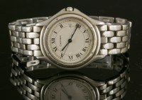 Lot 384 - A stainless steel Cartier steel Panthère round mid-size quartz bracelet watch