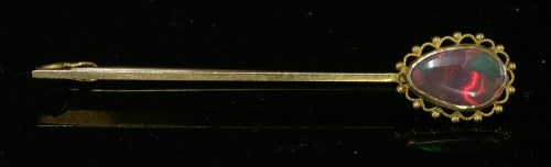 Lot 69 - A single stone black opal bar brooch or tiepin