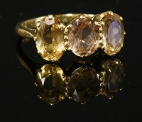 Lot 260 - An 18ct gold three stone topaz ring