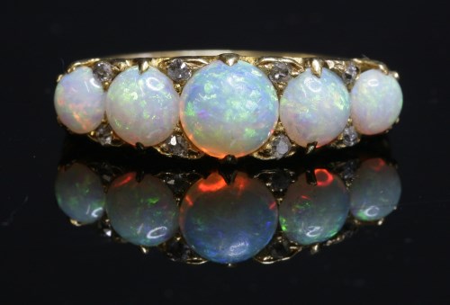 Lot 68 - A Victorian five stone opal carved head ring
