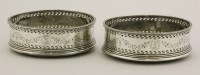 Lot 419 - A pair of George III Irish silver wine coasters