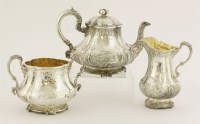Lot 424 - A Victorian and George V silver composite three-piece tea service