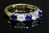 Lot 300 - An 18ct gold five stone sapphire and diamond half hoop ring