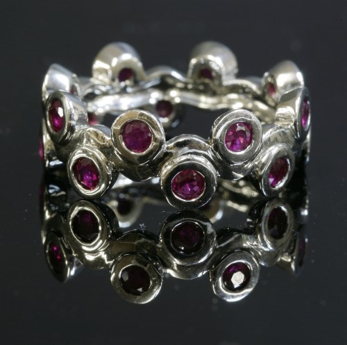 Lot 316 - A Continental white gold ruby band ring