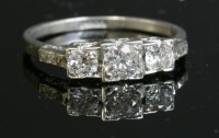 Lot 164 - An Art Deco three stone diamond ring