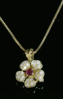 Lot 269 - An 18ct gold ruby and diamond flower head pendant