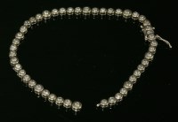 Lot 309 - A white gold diamond set line bracelet