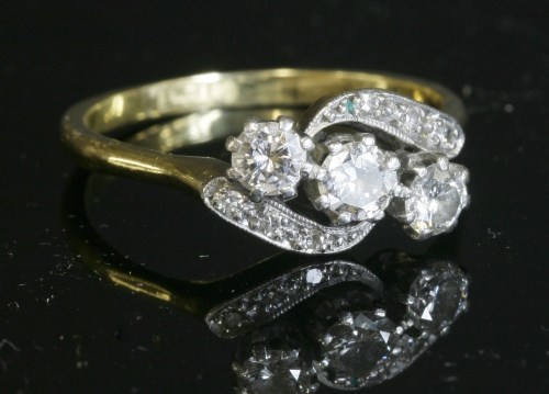 Lot 288 - A three stone diamond crossover ring