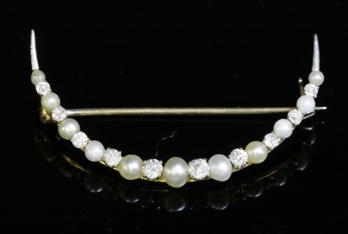 Lot 95 - A diamond and seed pearl open crescent brooch