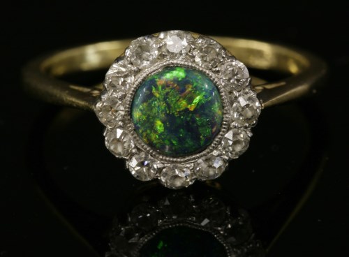 Lot 70 - A black opal and diamond daisy cluster ring