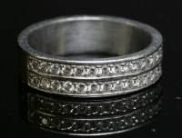Lot 312 - A platinum two-row diamond set half eternity ring