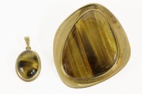 Lot 3 - A gold rub set freeform tiger's eye cabochon brooch/pendant