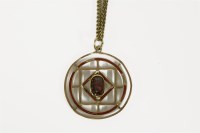 Lot 33 - An Edwardian gold single stone garnet and red enamel pendant