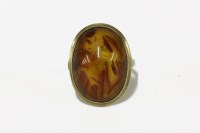 Lot 26 - A single stone amber cabochon ring