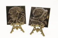 Lot 300 - A pair of brass miniature easels