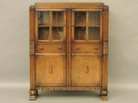 Lot 497 - A 1950's oak display cabinet