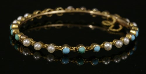 Lot 97 - A late Victorian turquoise and split pearl hinged bangle
