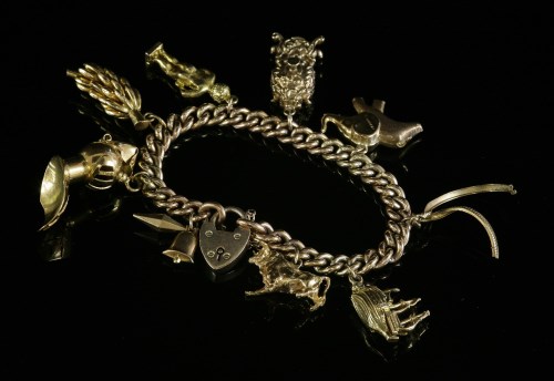 Lot 215 - A gold curb link charm bracelet