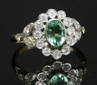 Lot 278 - An emerald and diamond oval cluster ring