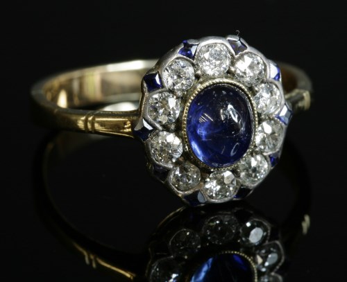 Lot 157 - A sapphire and diamond oval cluster ring