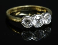 Lot 294 - An 18ct two colour gold three stone diamond ring