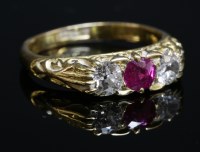 Lot 83 - An Edwardian three stone ruby and diamond carved head ring
